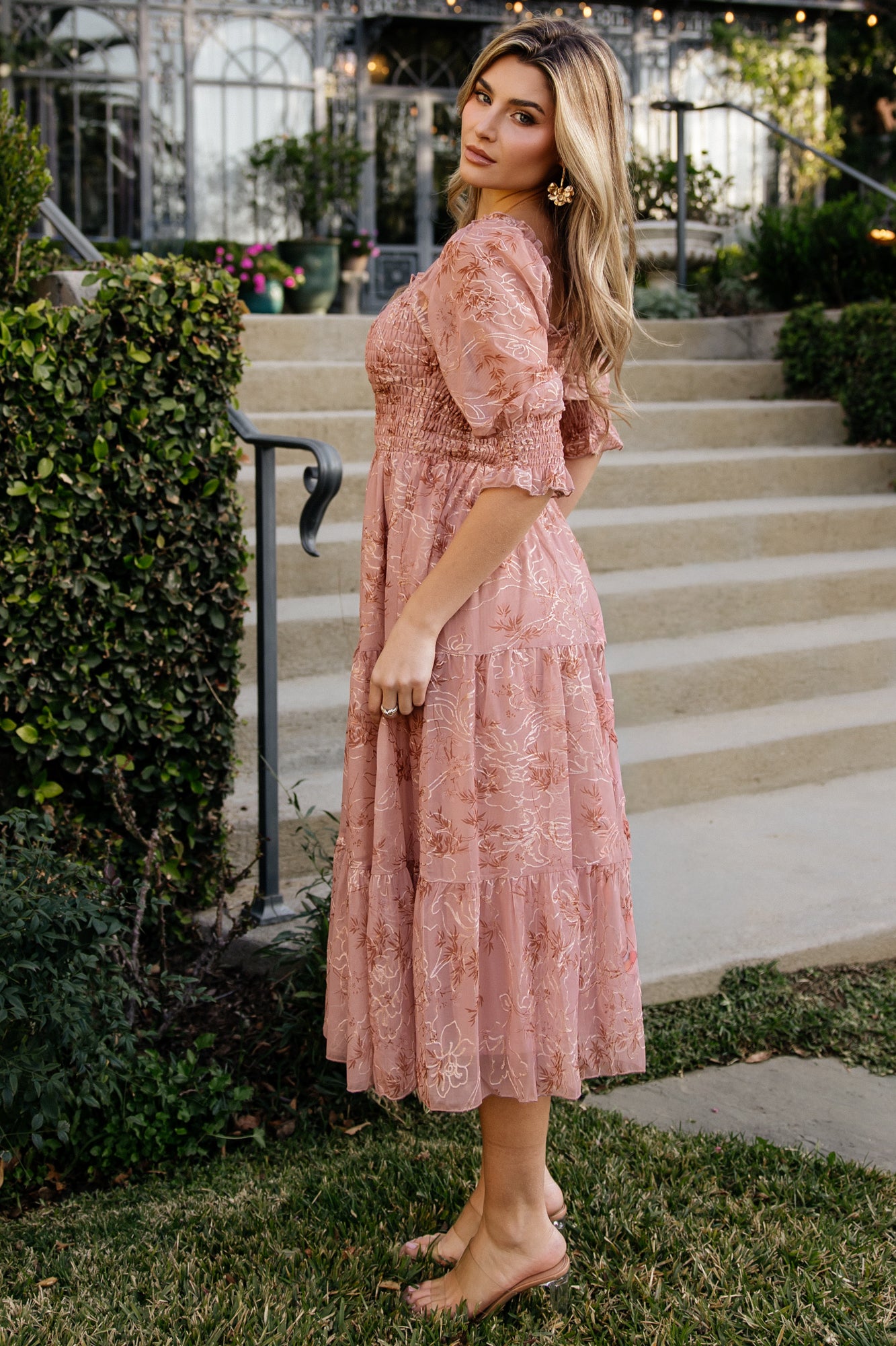 Movement shot of the Fabian Midi Dress in Mauve + Gold, highlighting the tiered skirt flow and lined midi length while sleeves remain airy and unlined.