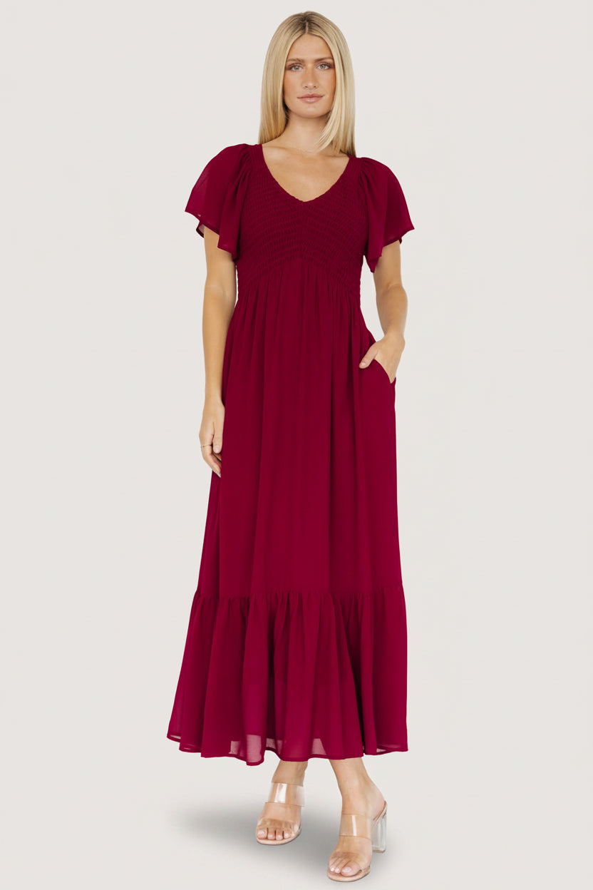 Detail photo of flutter sleeve hem and smocked shoulder seam on lightweight mulberry chiffon fabric.