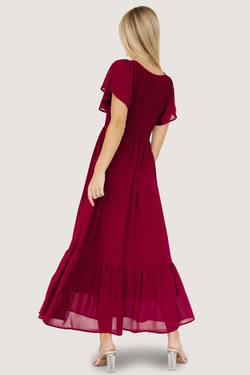 Side view showing hidden side pocket and lined chiffon skirt with single bottom tier on the Monica Smocked Dress.