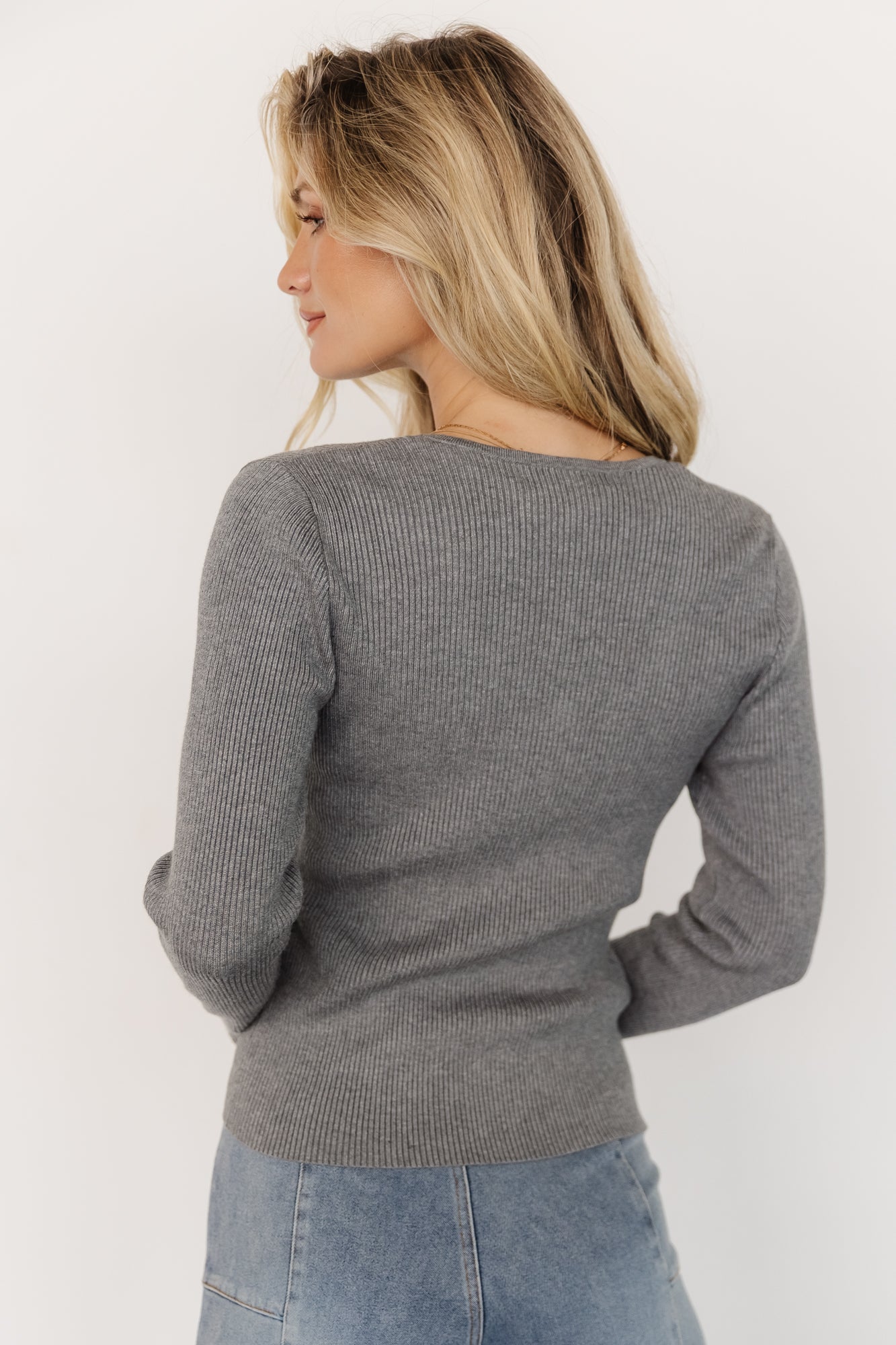 Back view of the Leo Ribbed Henley Top on model, showing smooth drape, ribbed knit texture, and fitted silhouette.