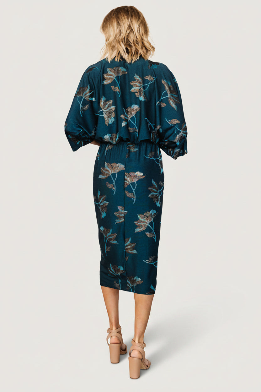 Model wearing the Jade Floral Shimmer Shaneen dress, styled for an event with subtle shimmer, ruched waist and easy movement in skirt.