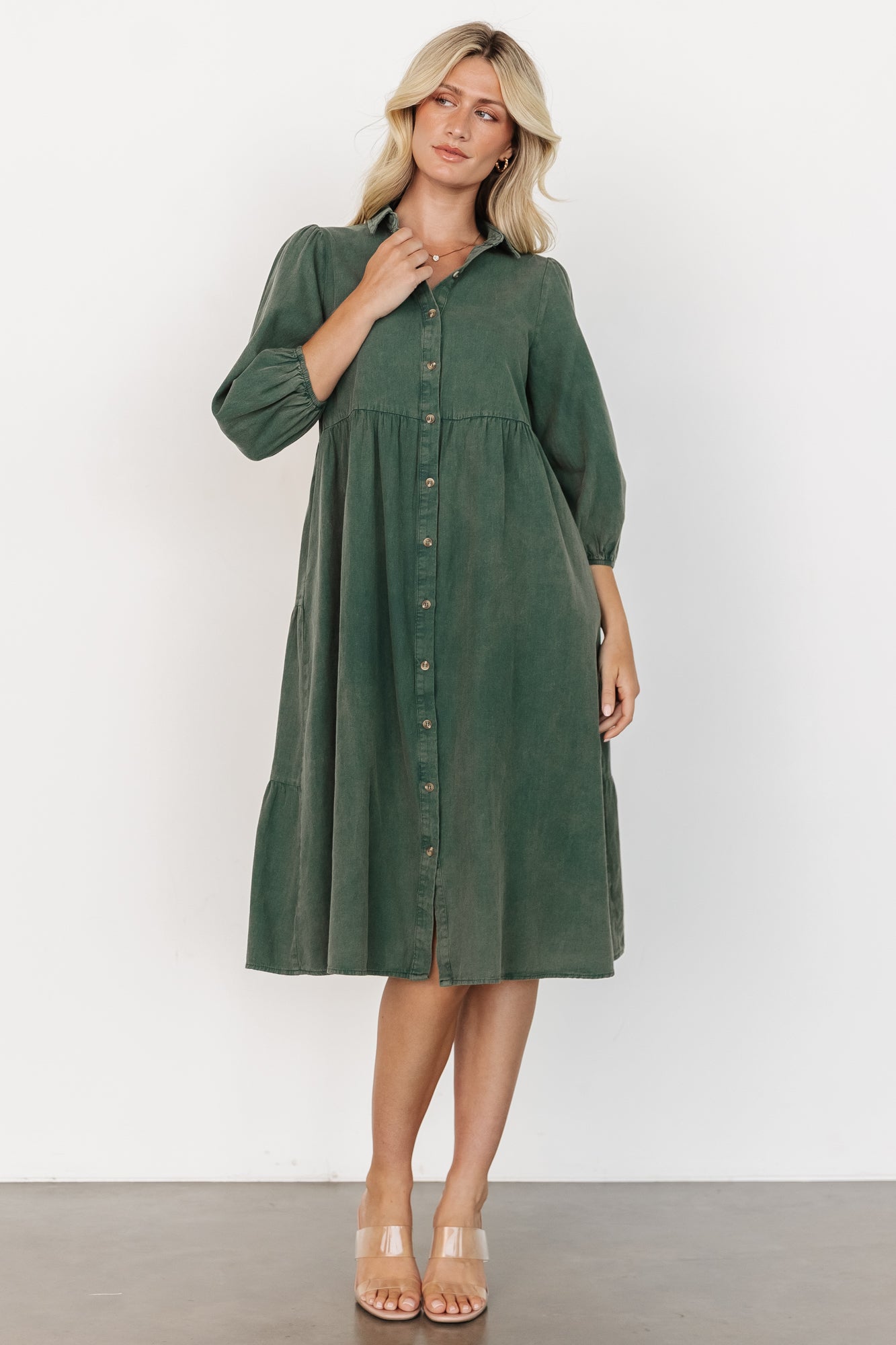 Casual styling shot of the green Sari Babydoll Dress paired with boots, showing length, movement, and easy everyday wearability.