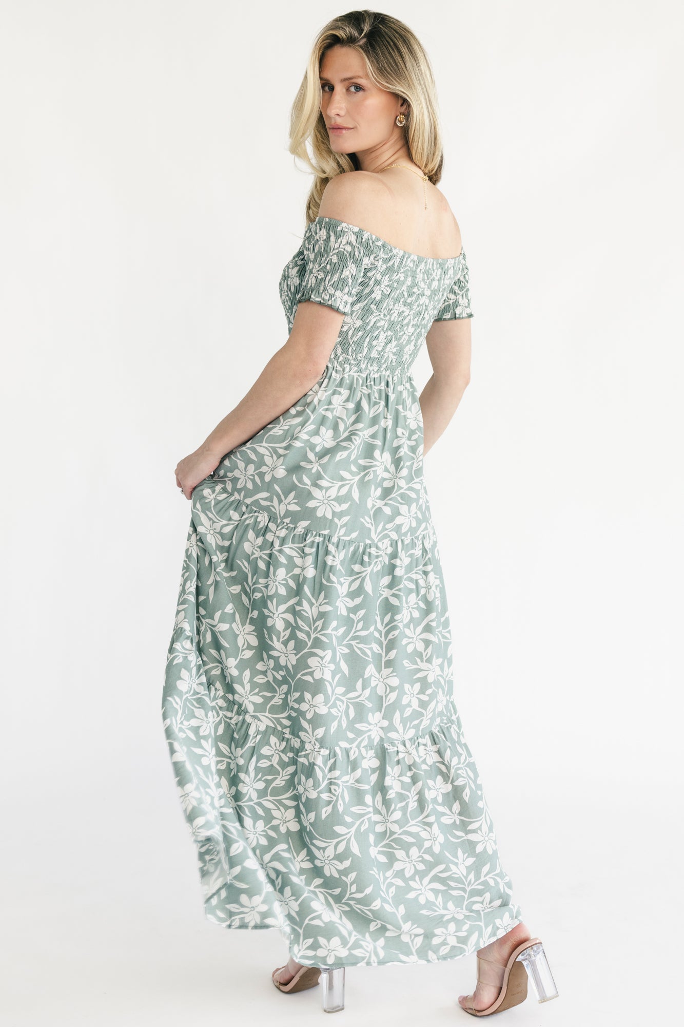Styled shot of the Payton dress in dusty sage, showcasing overall silhouette, tiered hem, and romantic floral pattern.