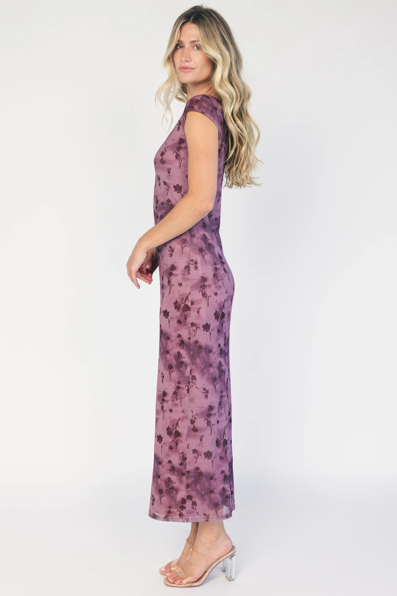 Model wearing a dusty plum floral mesh midi dress with a round neckline, short sleeves, and a fitted bodycon silhouette.