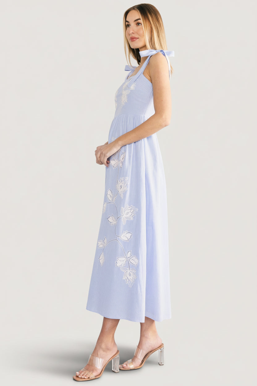 Close-up of square neckline and self-tie straps on the Enora embroidered maxi dress showing stitching and lining.