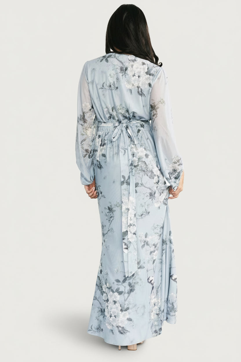Back view of the maxi dress on model highlighting empire waist with back elastic band and attached waist tie.