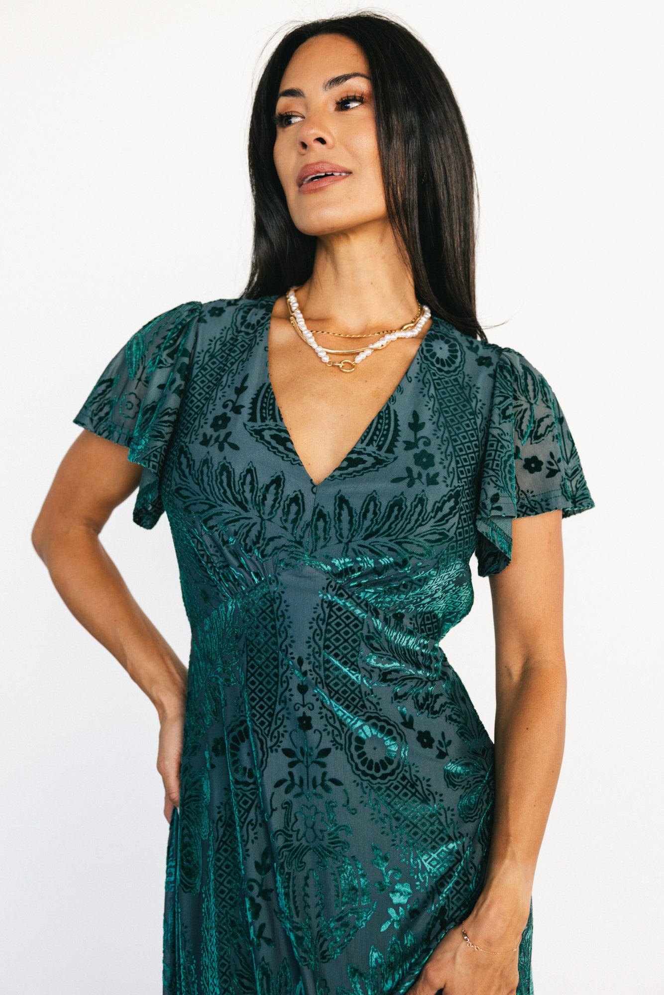 Three-quarter view of the Kimberly emerald velvet burnout maxi dress highlighting short flutter sleeves and textured velvet floral burnout.