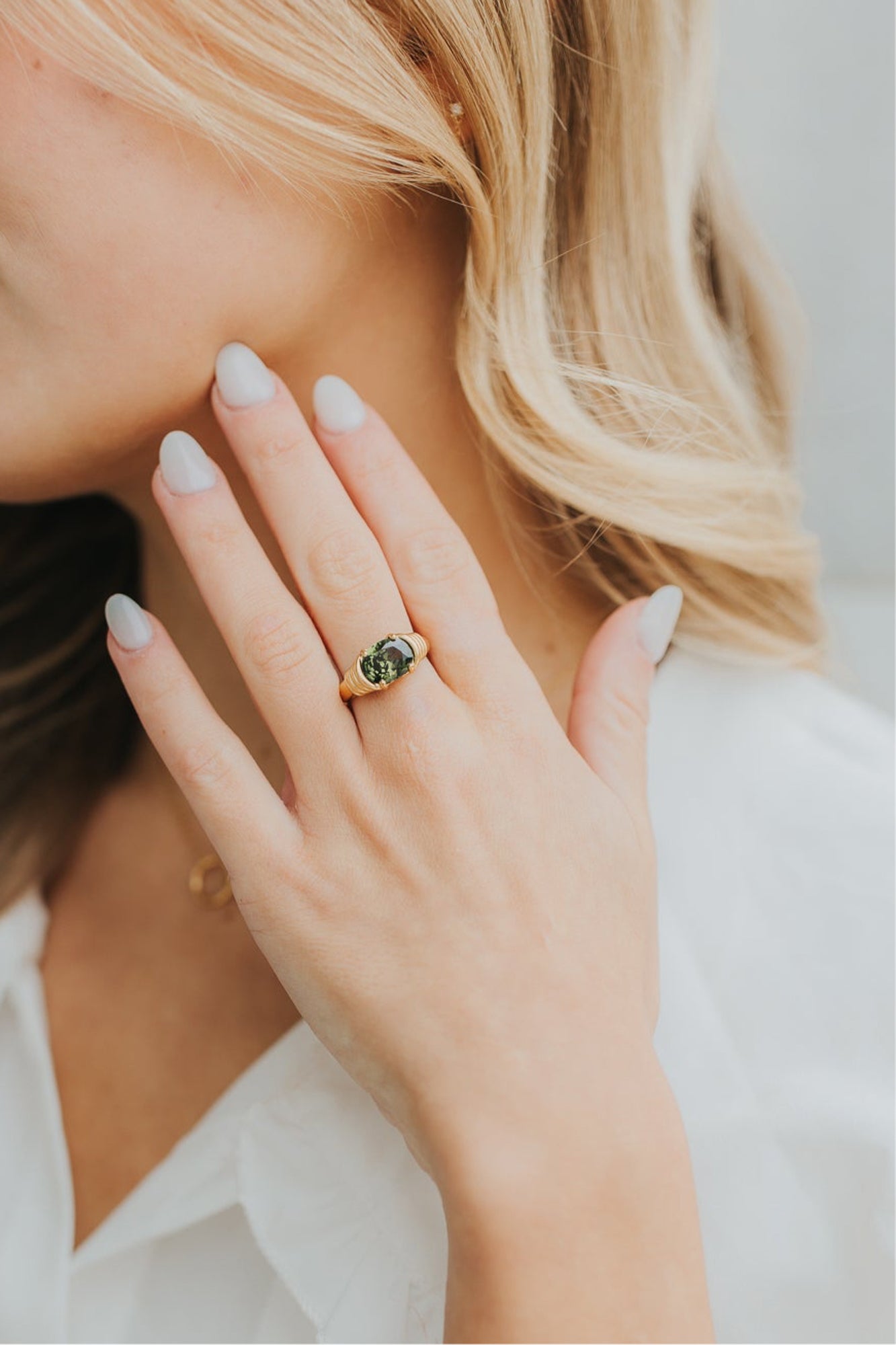 Model hand wearing The Maddie ring to display fit, proportion, and how it complements other accessories.