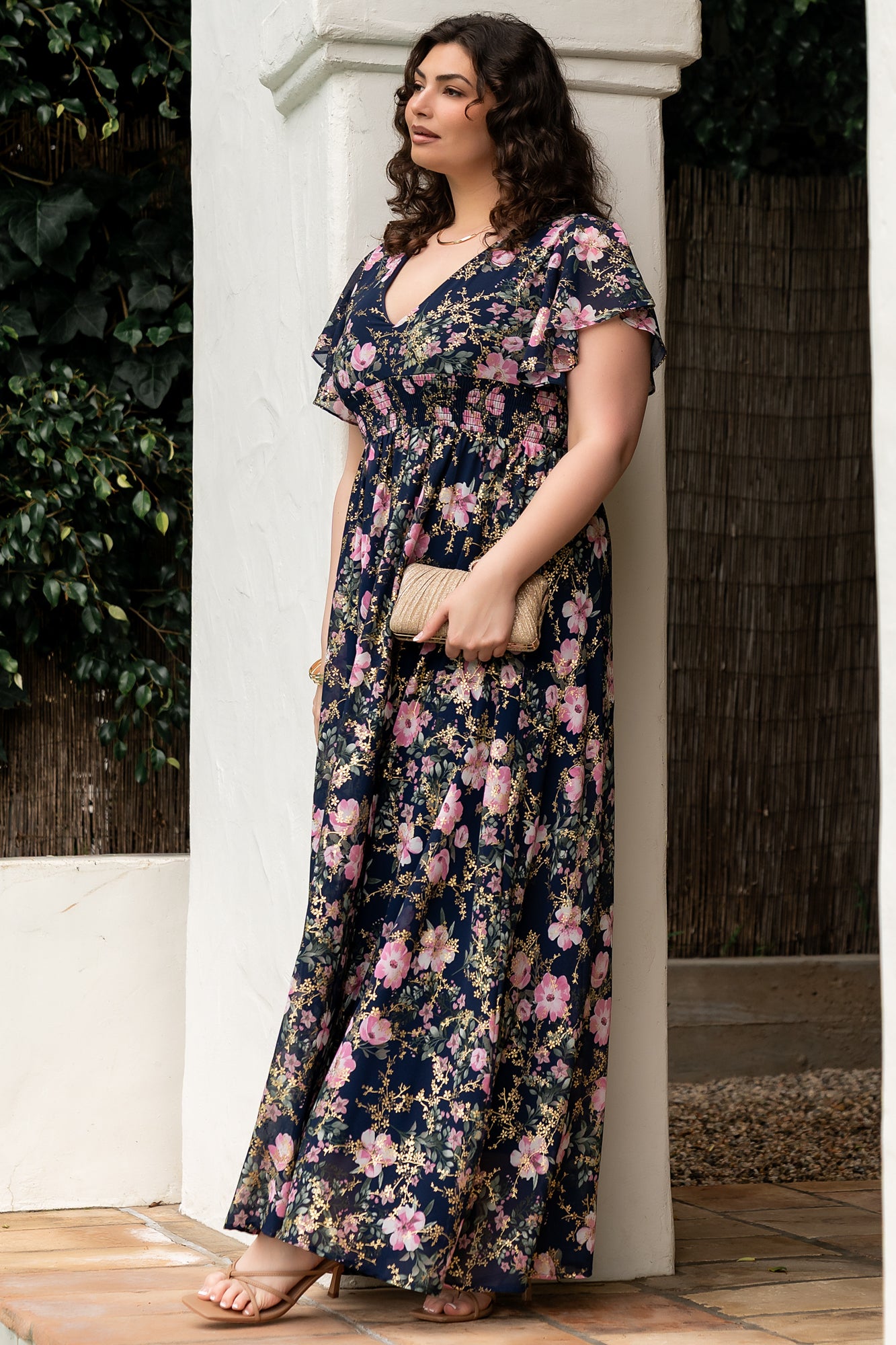 Full-length shot of the Lynlee metallic maxi dress in dark blue and pink, showing movement of the chiffon skirt and subtle metallic threading throughout.