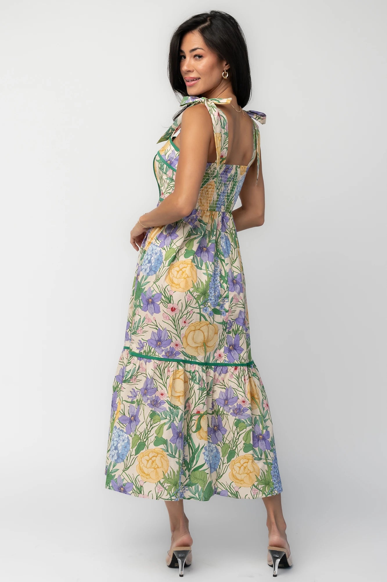 Model wearing the Torres Midi Dress featuring a multicolor floral print with green accents.