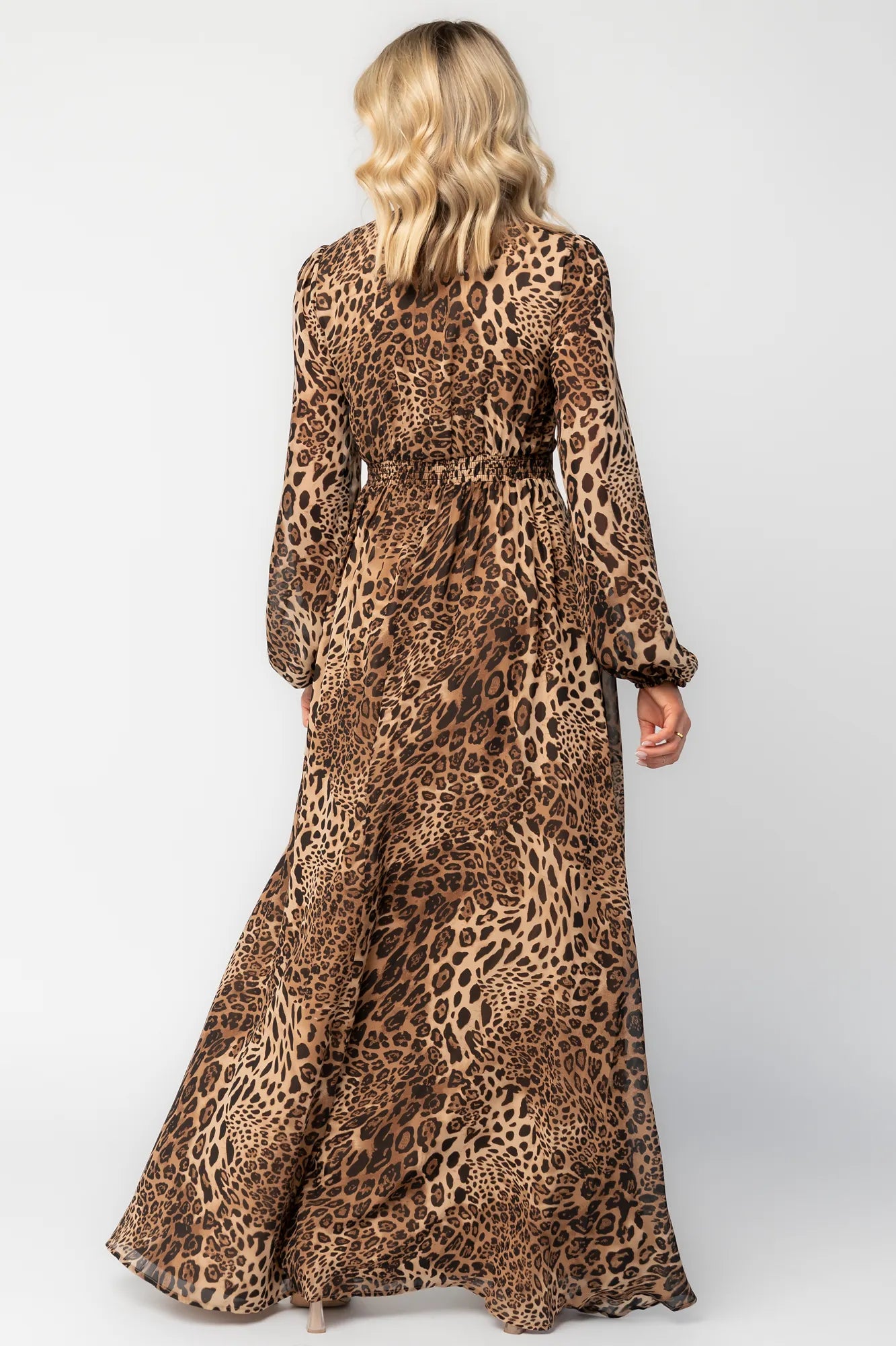 Model wearing a maxi dress with a mixed animal print, featuring a V-neckline with a keyhole cutout and front tie detail.