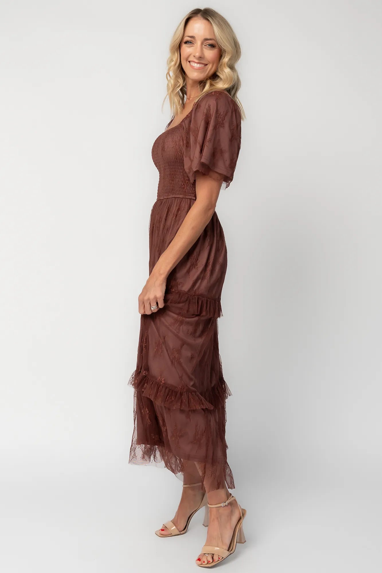 Model wearing a mahogany lace maxi dress with a square neckline, short sleeves, and a smocked bodice.