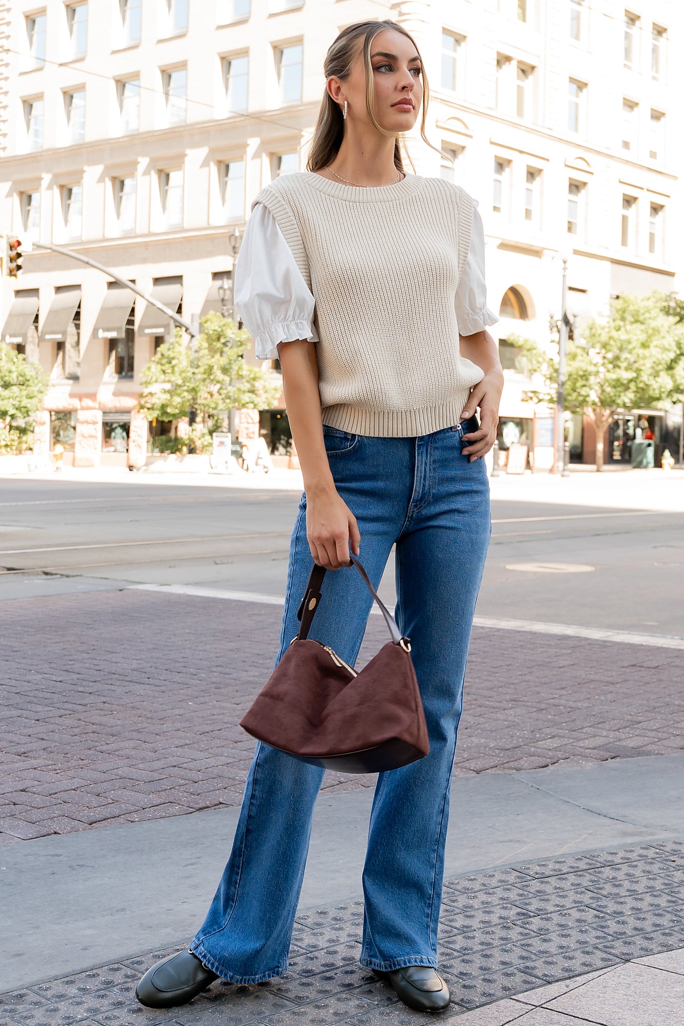 Close-up detail of the Taylor Top showing textured cream knit, attached ivory cotton puff sleeve and elastic sleeve cuff construction.