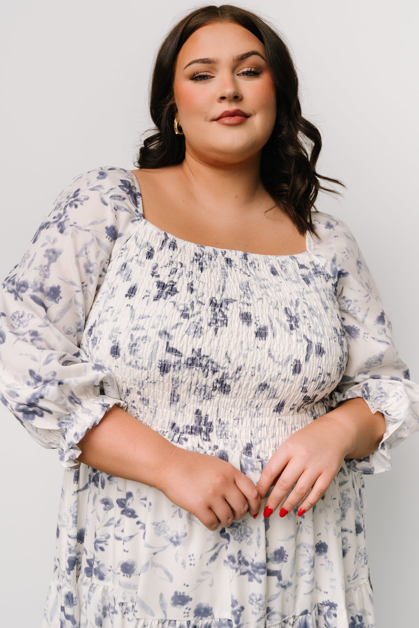 Styled flat-lay of Marta Smocked Midi Dress fabric and pattern showing blue floral print and lightweight polyester weave.