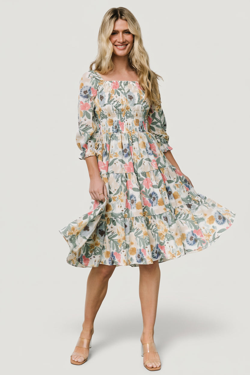 Styled outfit image of the multi floral smocked midi dress paired with casual sandals to show event-ready styling options.