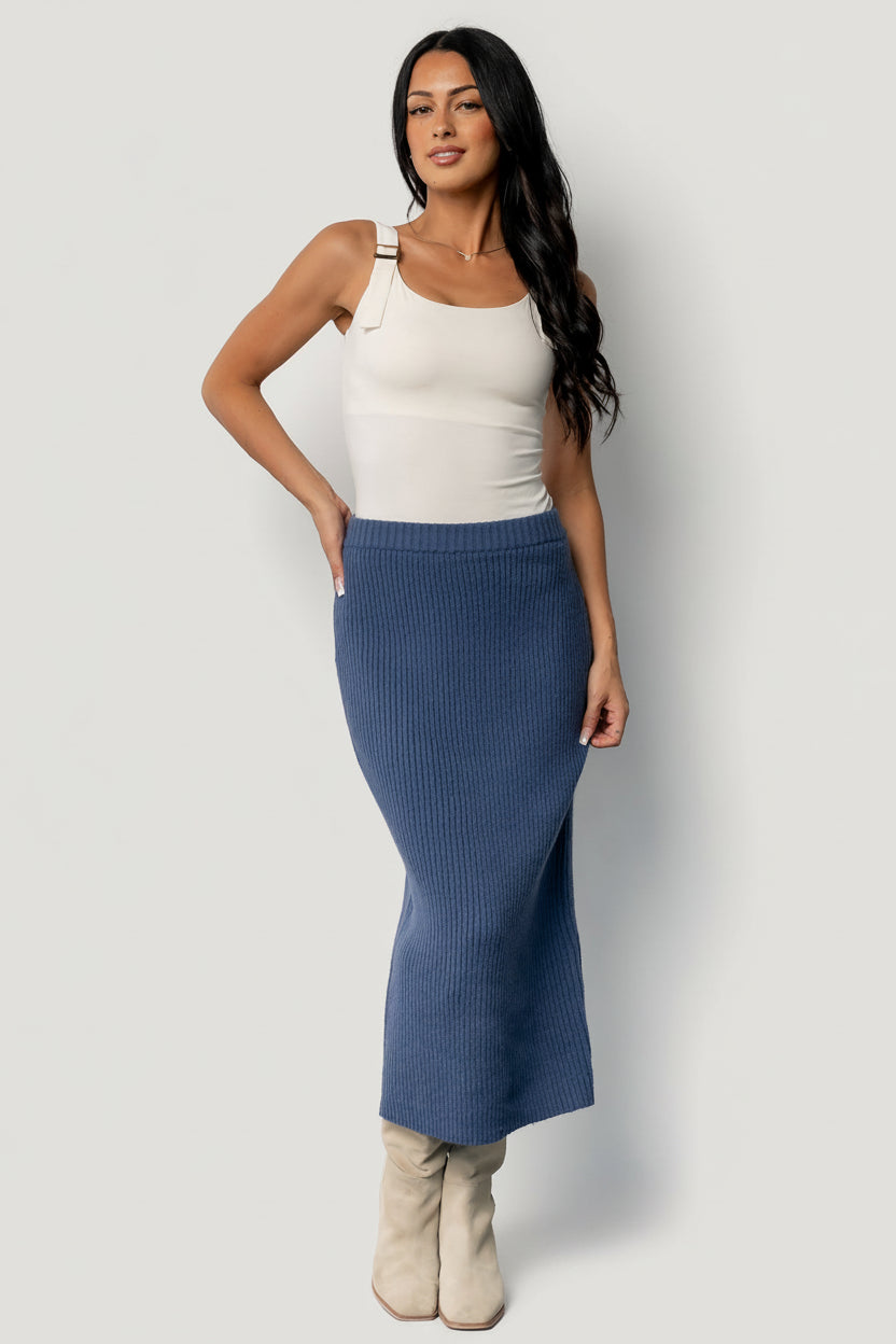 Close-up of the ribbed knit fabric and waistband showing knit texture, stitch detail, and the elastic stretch that provides a comfortable fit.