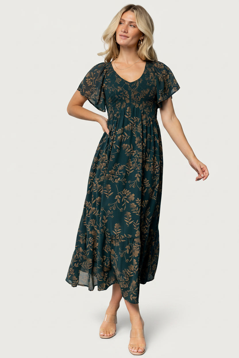 Detail image of the Monica dress fabric and gold print pattern on deep topaz chiffon, emphasizing print scale and lightweight texture.