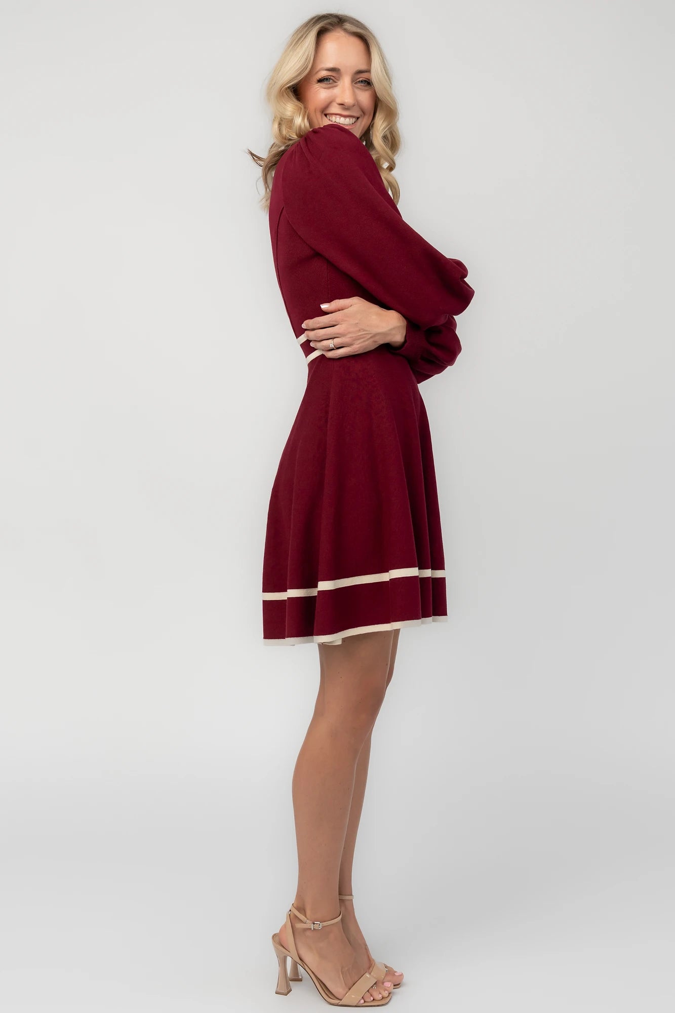 Rich wine knit mini dress with cream contrast trim, long balloon sleeves, a fitted waist, and a flared skirt.