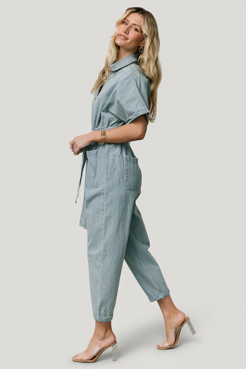 Lifestyle image of Mateo jumpsuit styled with sandals, illustrating cropped length, tapered silhouette, and casual versatility.