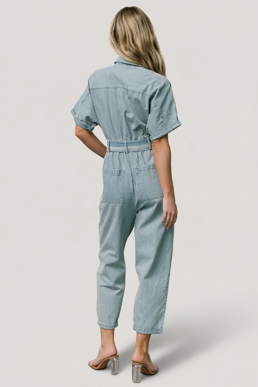 Detail shot of front leg pocket and stitched cuff on the Mateo denim jumpsuit, emphasizing pocket depth and finish.