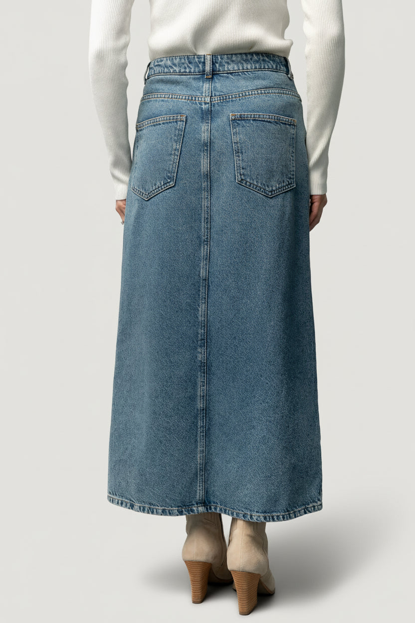 Detailed view of mustard topstitching and denim weave on the Aleksa midi skirt, highlighting finish and construction details.