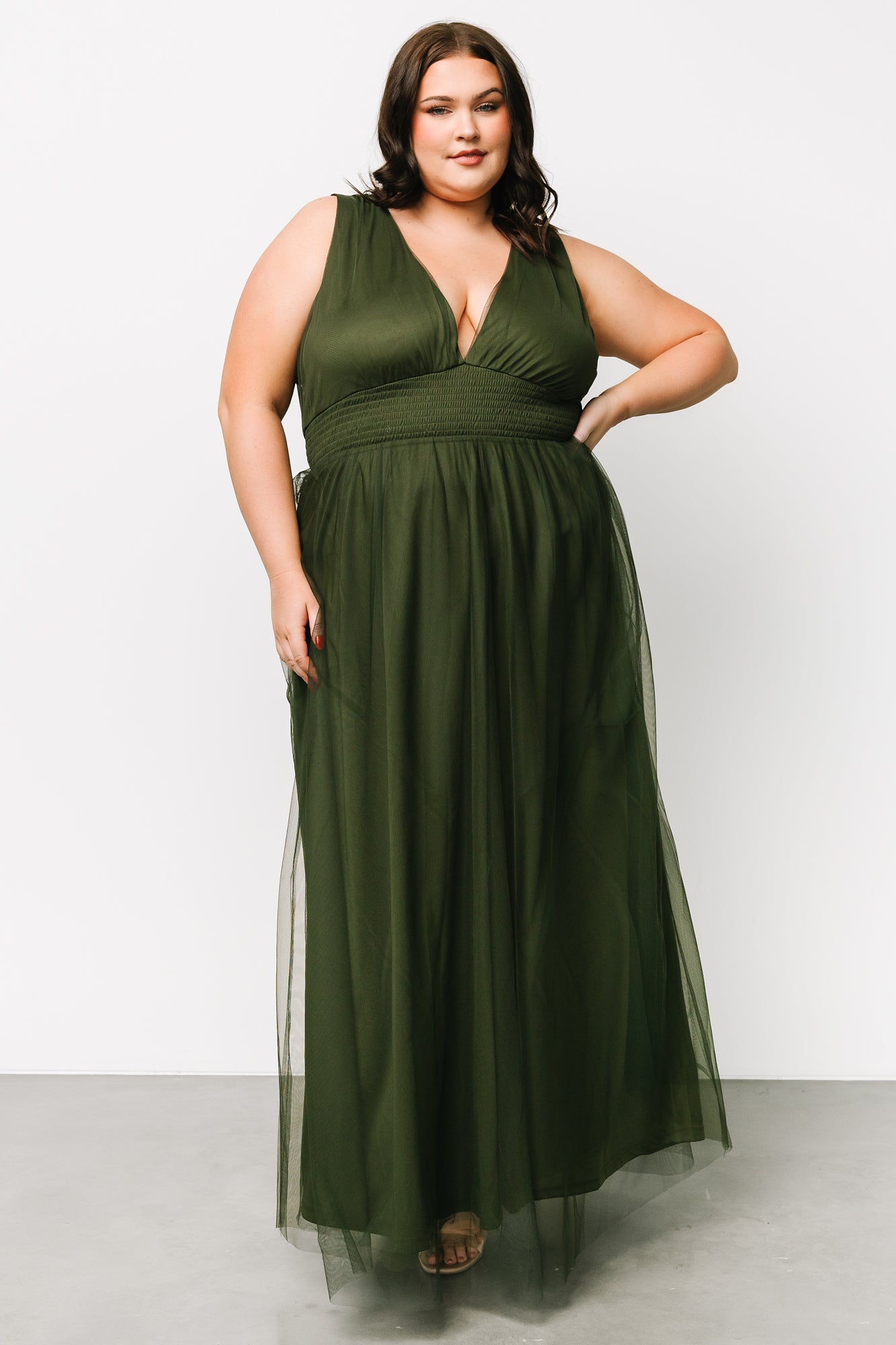 Three-quarter profile of Kamila Tulle Maxi Dress in Juniper Green showing short tank sleeves, fitted smocked waist, and soft tulle layers across the skirt.