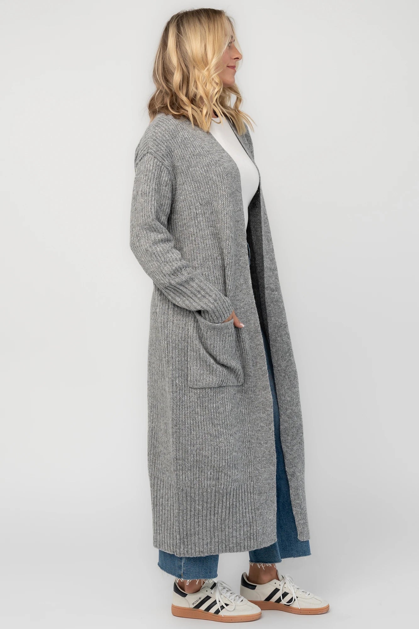 Heather gray ribbed long cardigan with an open front, long sleeves, front patch pockets, and a relaxed full-length silhouette.