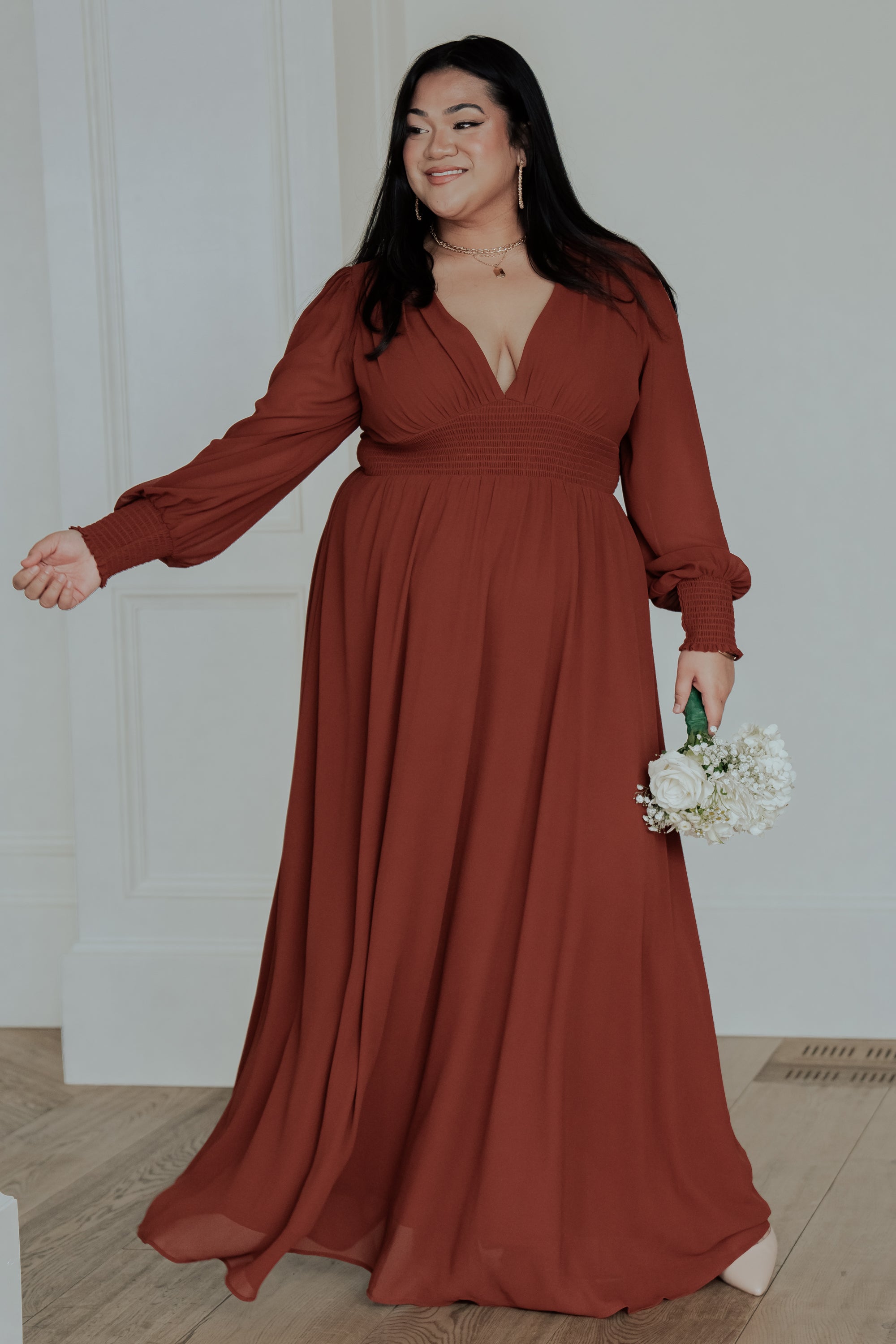 Close-up of Olivia Maxi Dress in cinnamon showing smocked sleeve cuff and lightweight chiffon texture, highlighting delicate drape and finish.