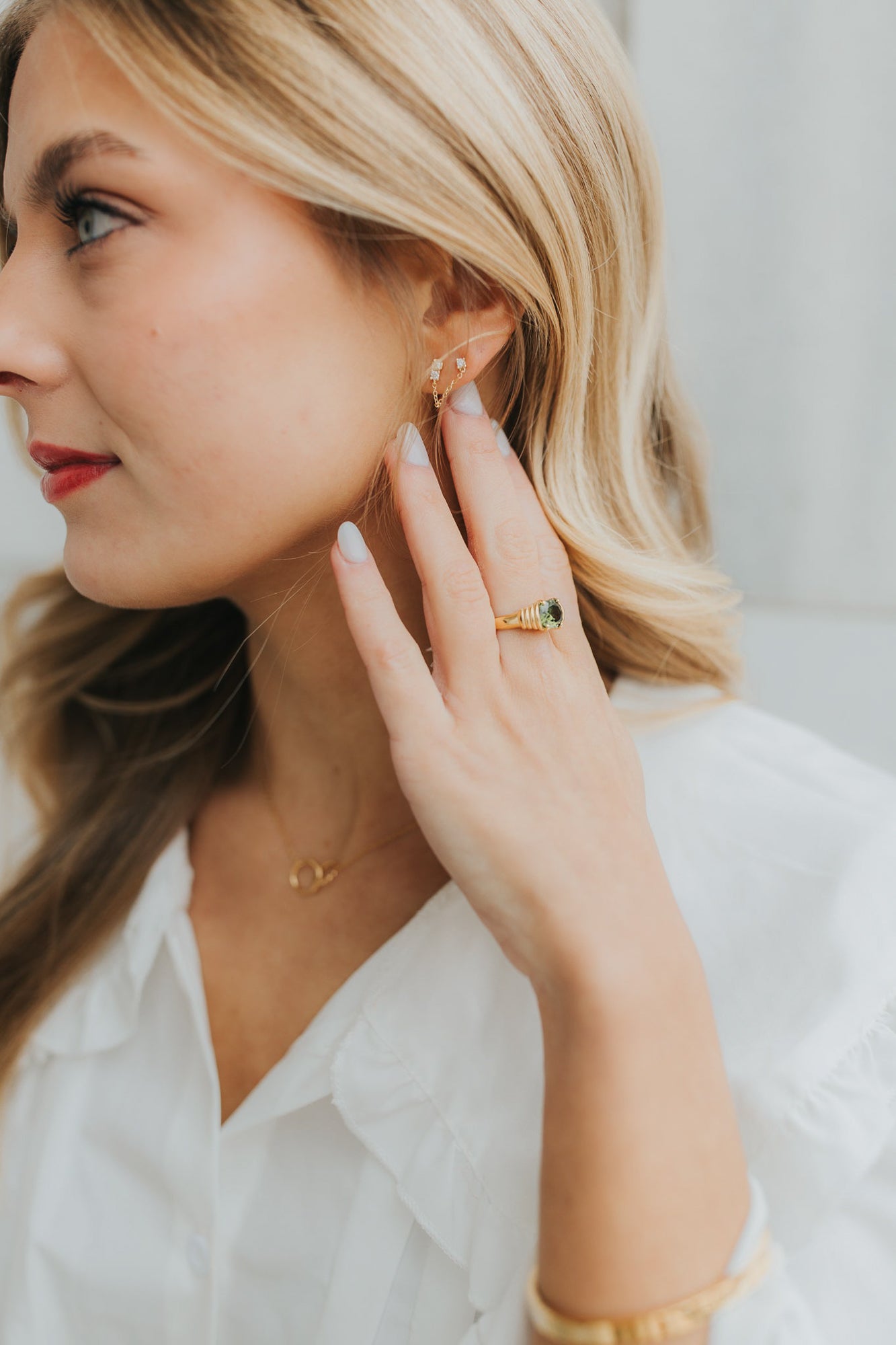 Side profile of the Maddie ring showing ribbed detailing along the band and the polished gold-plated finish.
