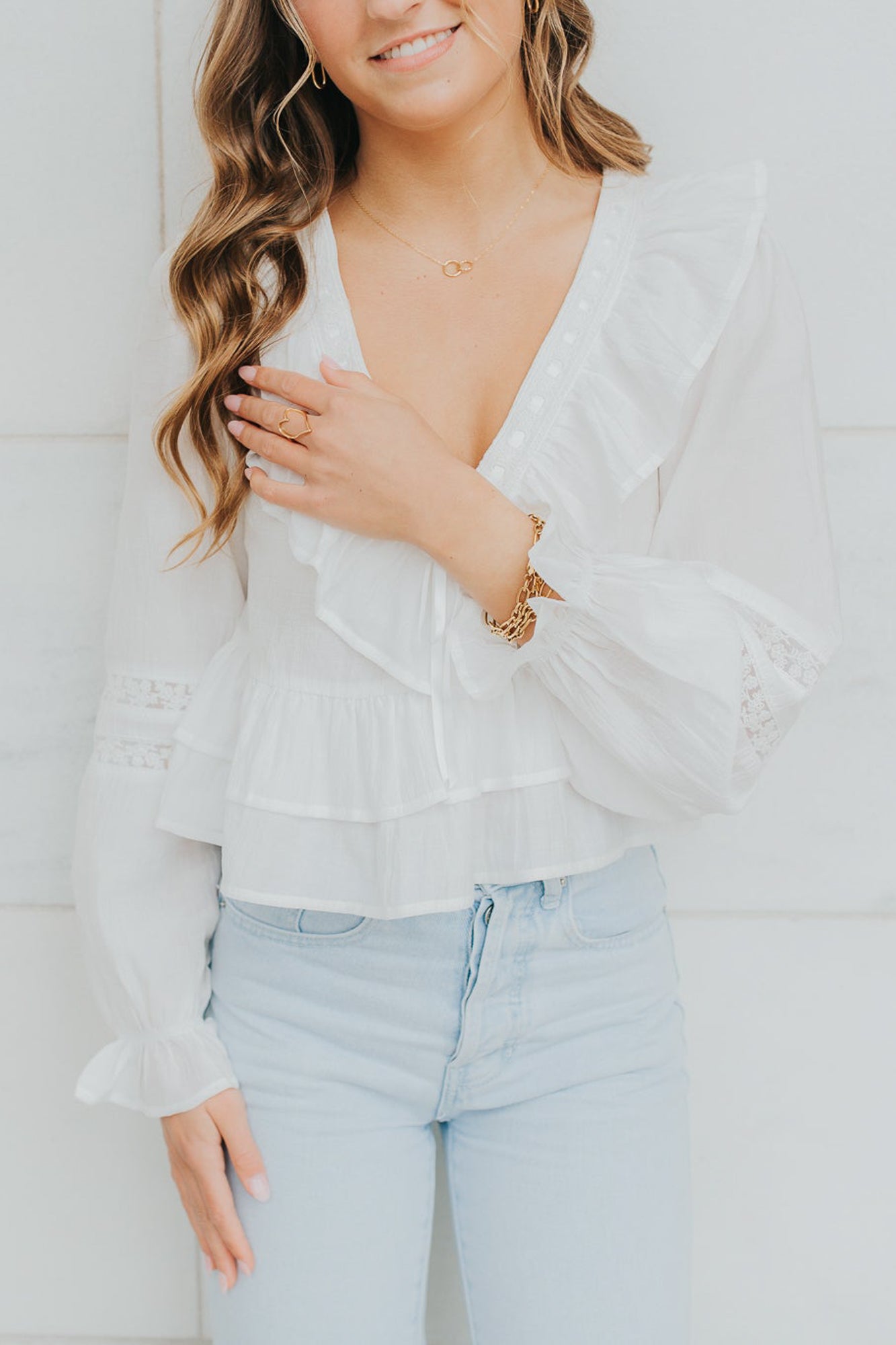 Close-up of jewelry assortment featuring The Mia Necklace alongside rings and bracelets to show coordination options.