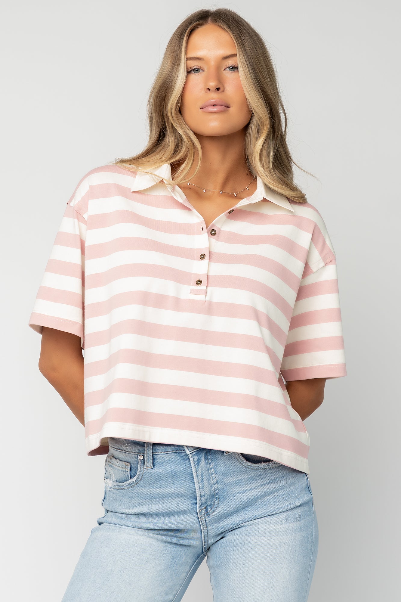 Flat-lay of Ruby Striped Top showing stripe pattern, short sleeves, collared finish, and unlined midweight construction.
