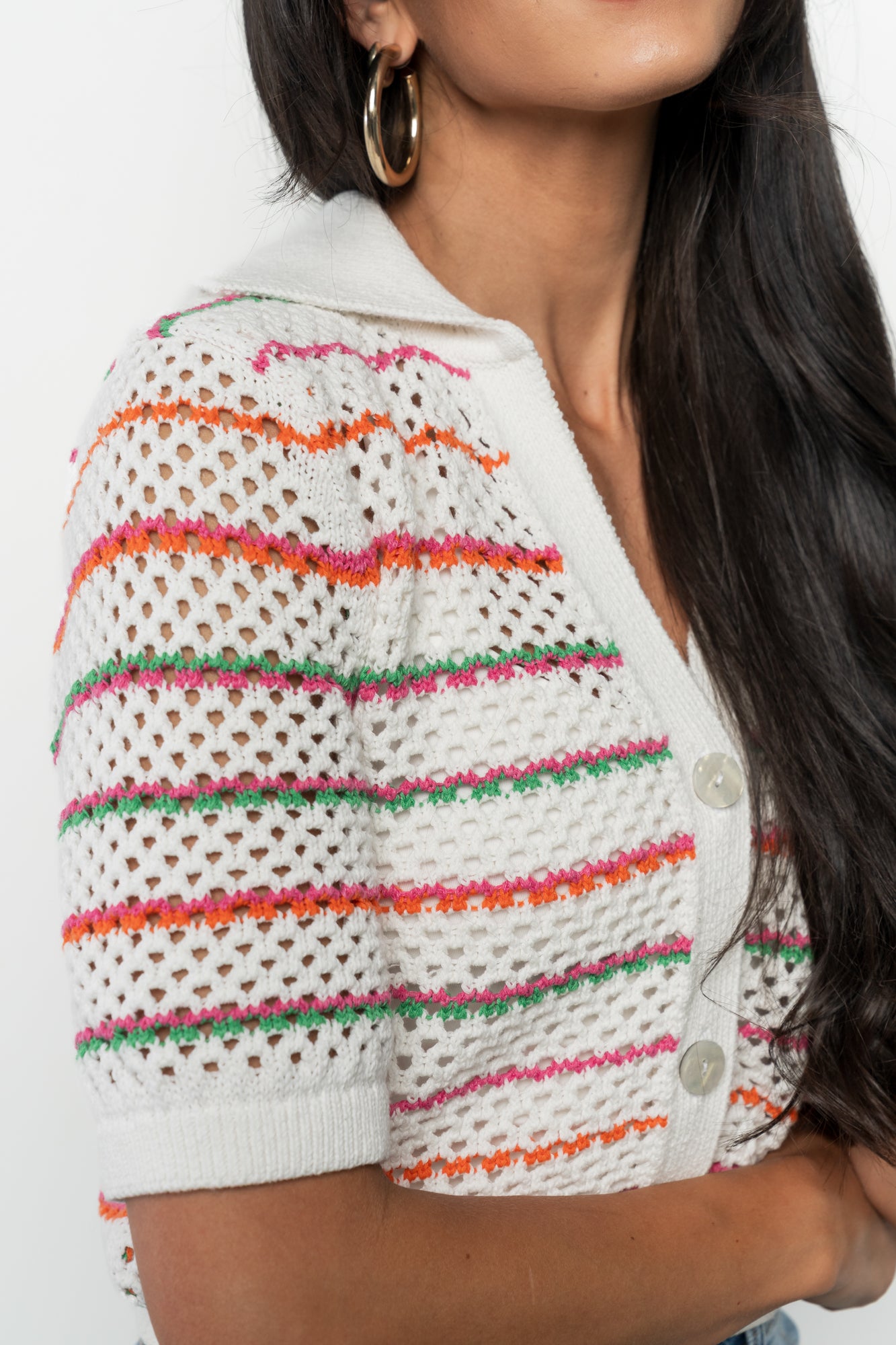 Flat-lay of Viento Multistripe crochet cardigan showing the white, pink, orange and green stripes, ribbed trim and slightly cropped shape.