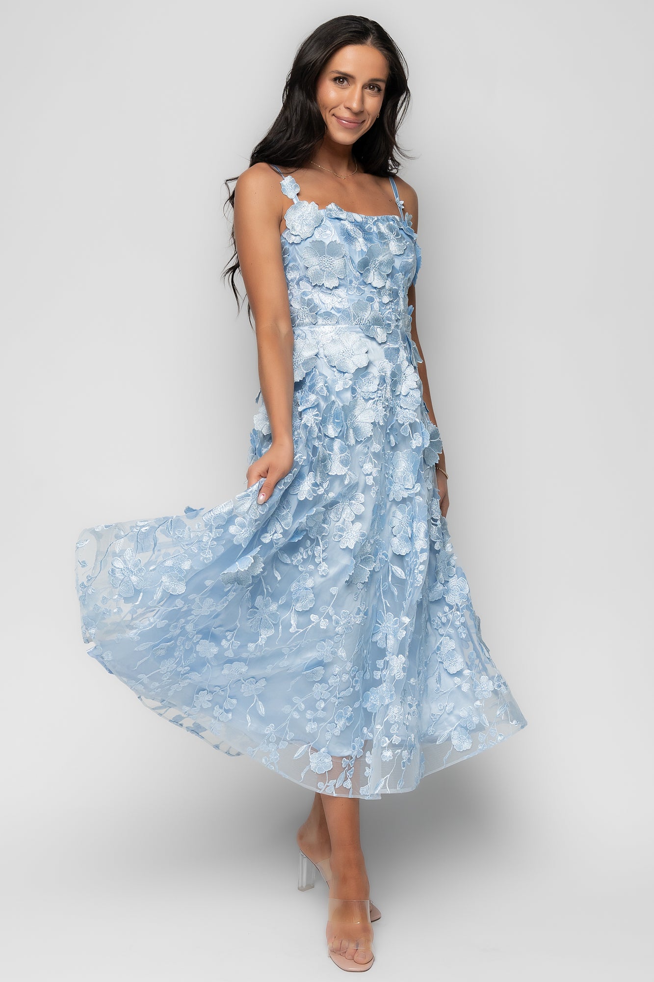 Styled flat-lay of the Soleil dress in light blue, fully lined, with visible hem structure and clean finishing.