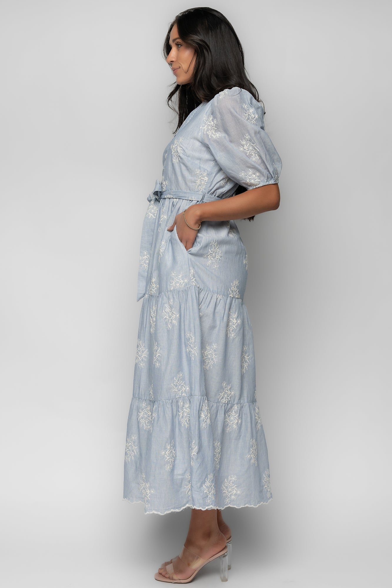 Model wearing Marguerite dress: full-length view of tiered skirt, short sleeves, scalloped hem and an airy fit ideal for warm-weather outfits.