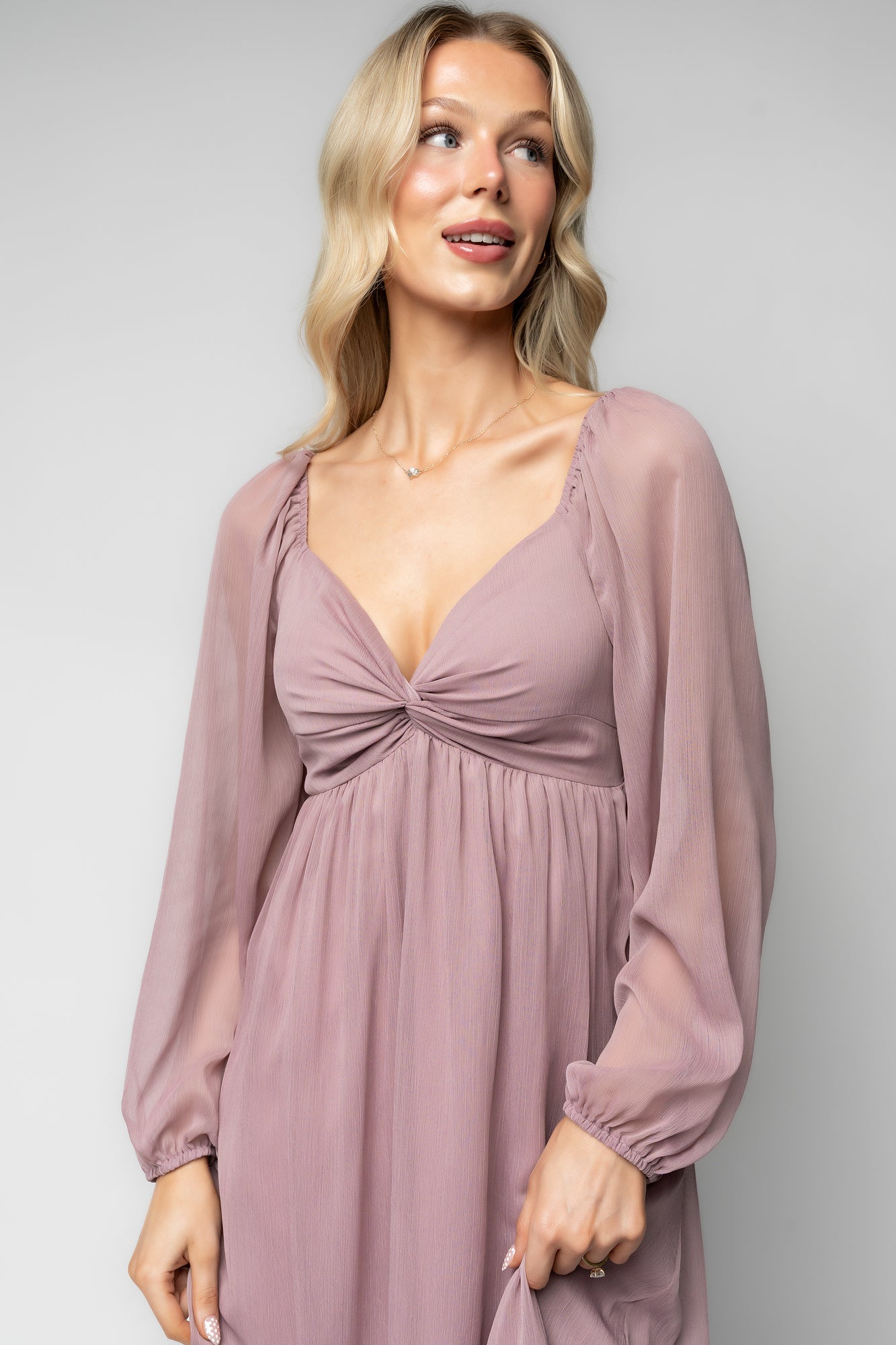 Model wearing Dione Midi Dress in dusty lilac styled with delicate jewelry, illustrating midi length and elegant silhouette for events.