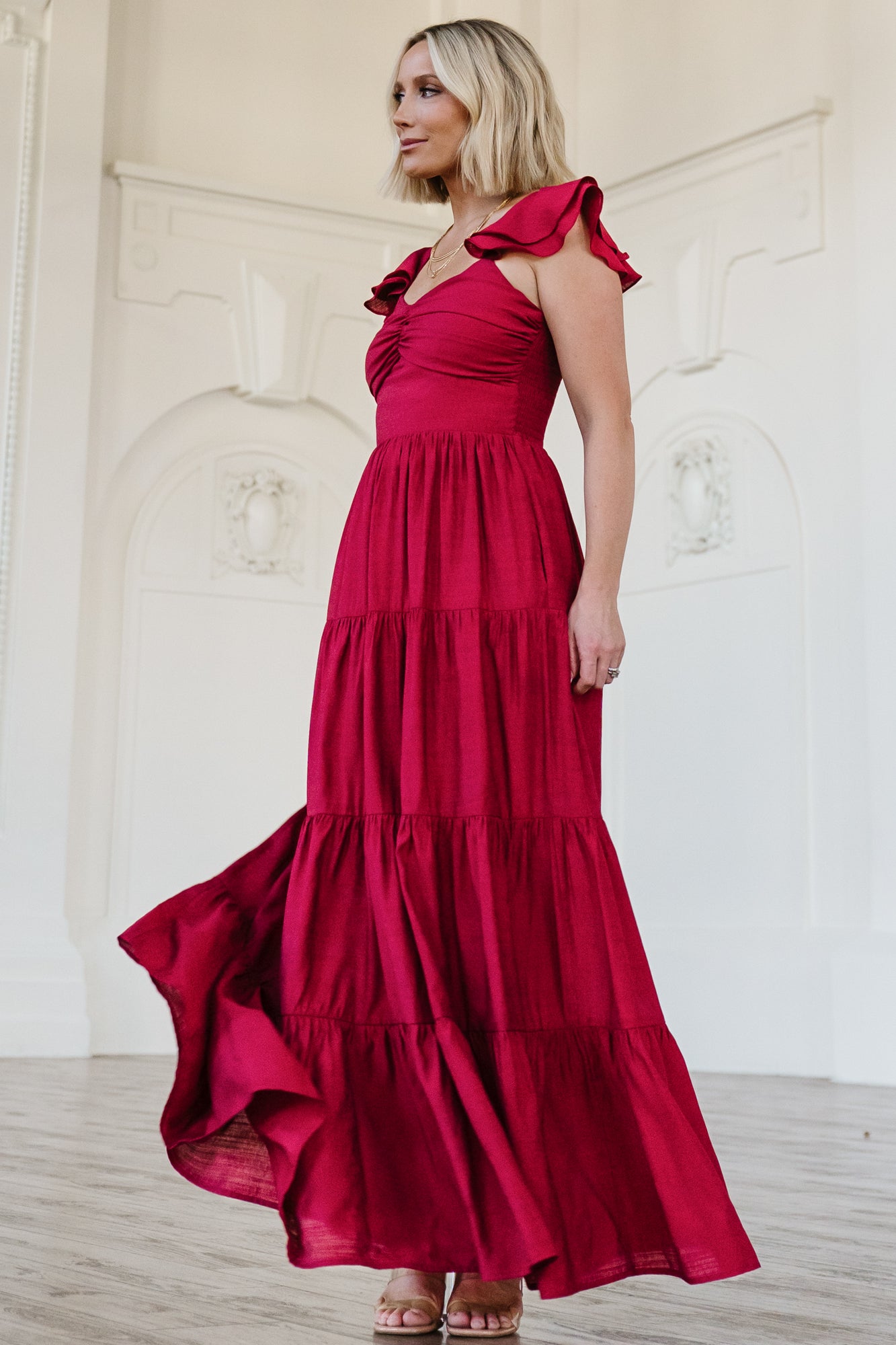 Detail image of the Vivianne Maxi Dress fabric and lining in deep red, showing ruffle tiers and the hemline finish above the lined section.