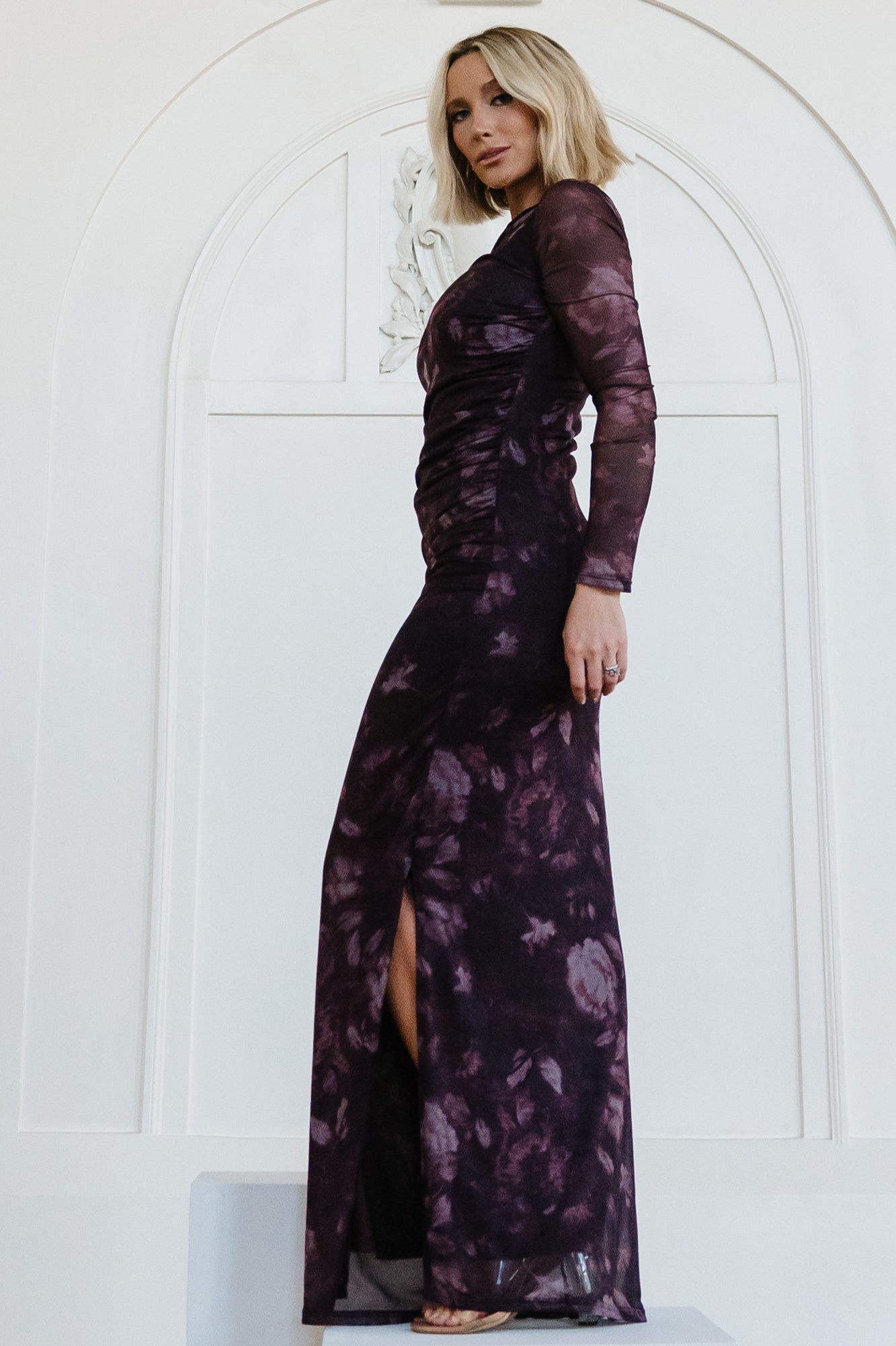 Model wearing the Isadora Maxi Dress, demonstrating fit and movement with thigh slit visible, ideal for evening occasions.