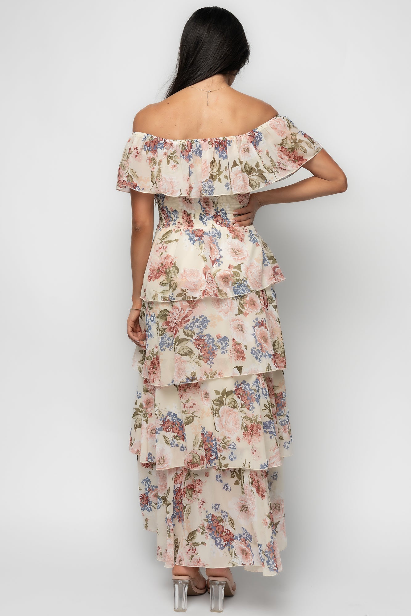 Detail close-up of the dress print and ruffle on the bust, showing texture of lightweight chiffon and the smocked, stretch waist.