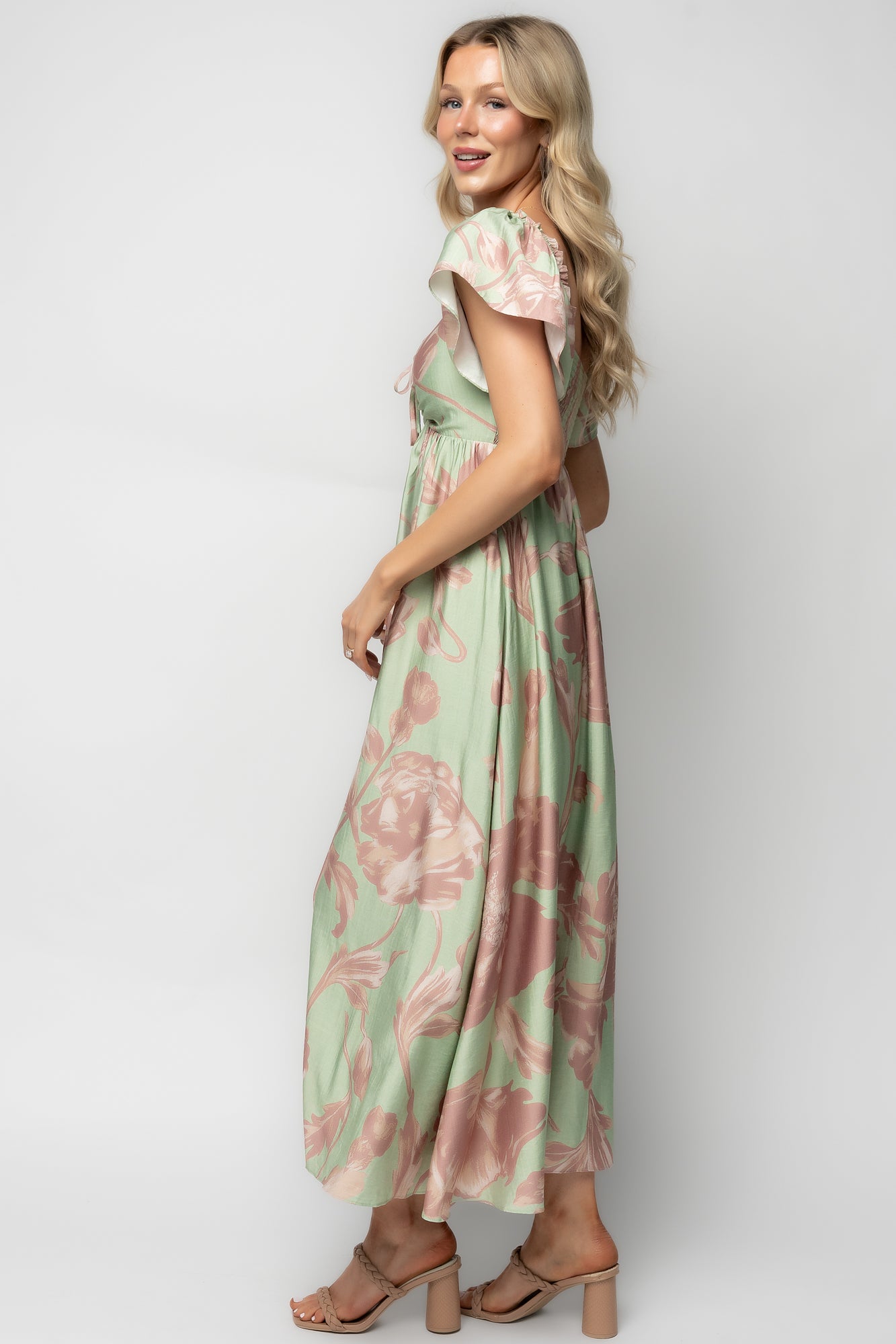 Close-up of the Eliana Maxi Dress fabric and lining edge illustrating the rose-pink floral motif on sage, fabric texture, and the fully lined construction of the body.