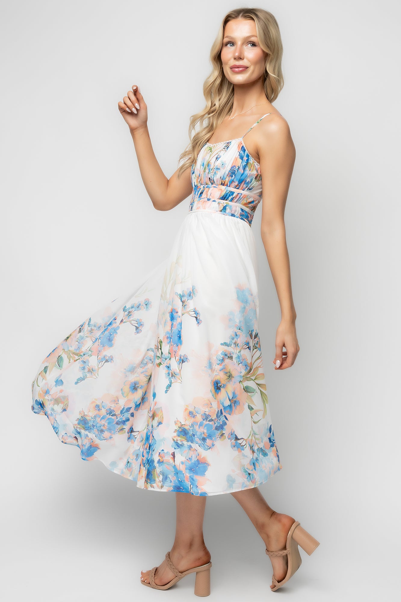 Styled full-length photo of model wearing the Marceline midi dress, showing the flowy skirt, midi silhouette, and fully lined construction.