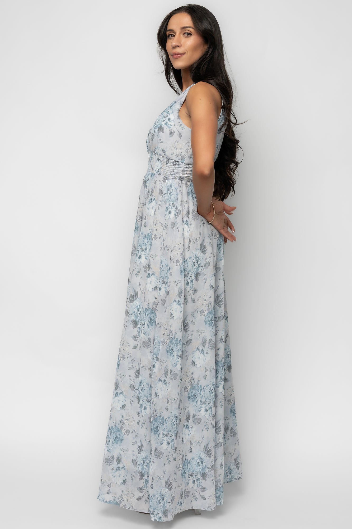 Detail image focusing on the smocked waist and hem of the Imogen Maxi Dress, showing fabric print, lining edge and stitch finish.
