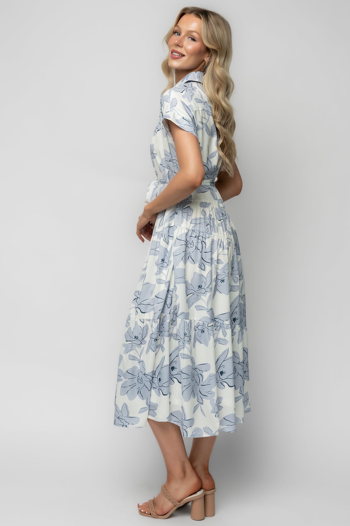Studio detail shot of the Claire dress sash, button placket, and fabric texture in ivory with light blue and navy floral print.