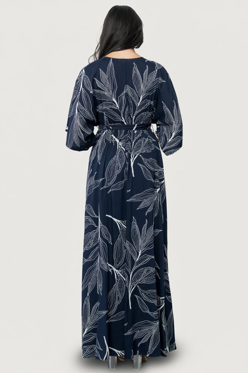 Three-quarter view of Kalea dress showcasing crossover surplice neckline, loose kimono sleeves and elastic waist with detached self-tie sash detail.