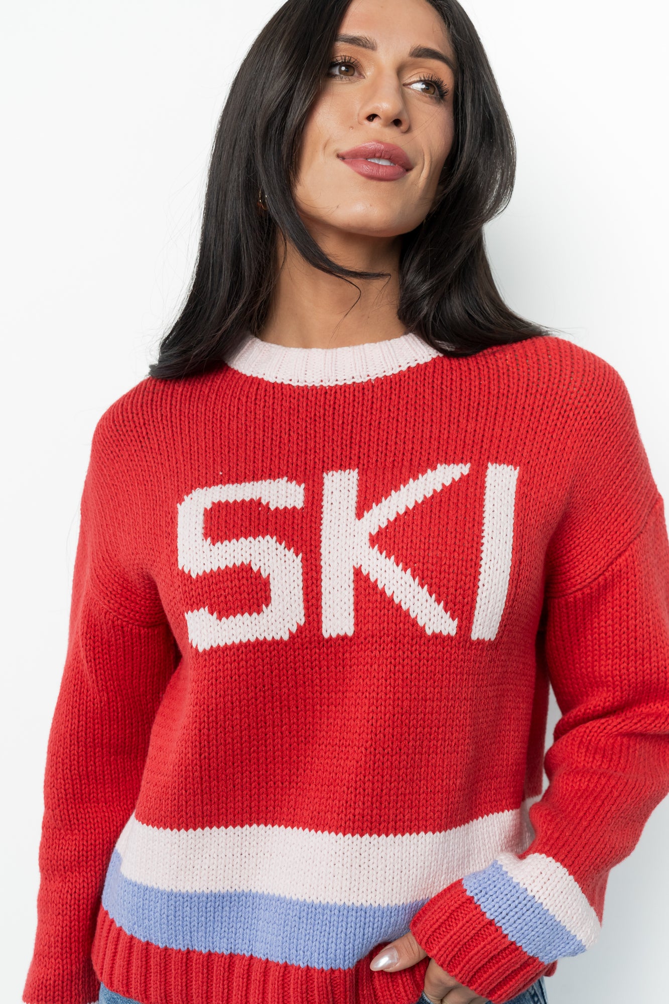 Detail view of the round neckline and cuff of the red multi Gilli ski sweater, illustrating the comfortable ribbing and knit construction.