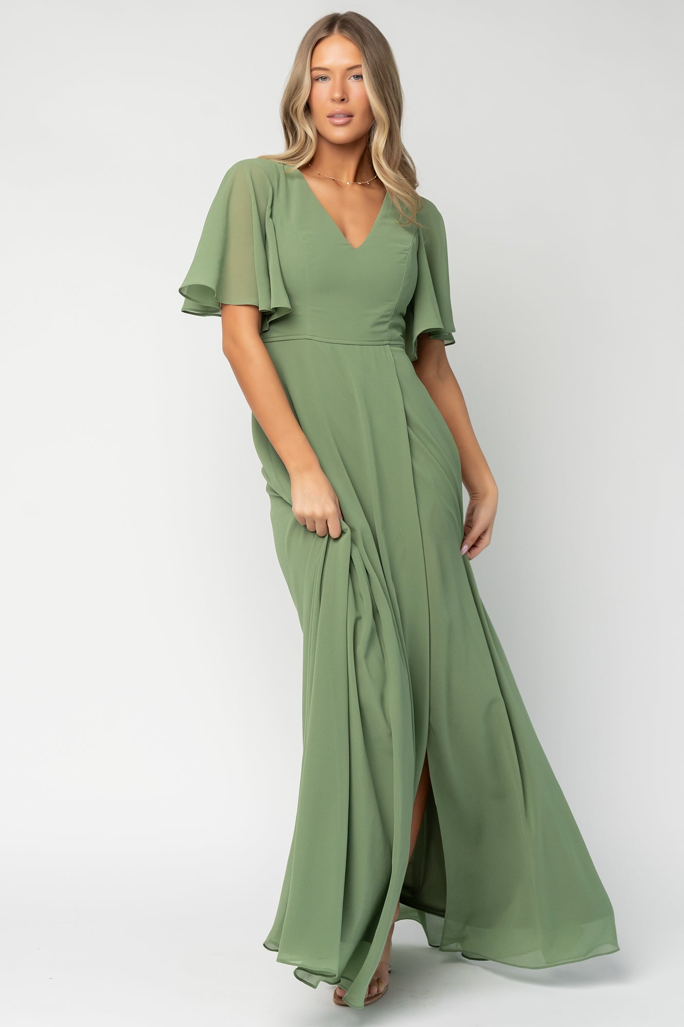 Detail shot of short flutter sleeve and neckline on olive Valetta chiffon dress, showing fabric texture and sleeve movement.
