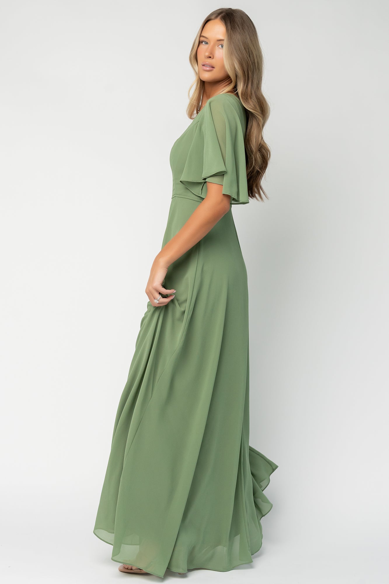 Styled flat-lay and hem view of olive Valetta maxi dress showcasing maxi length skirt and left-side slit for ease of movement.