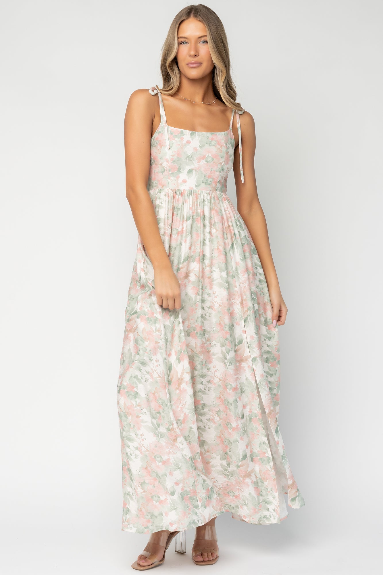 Back view of model in Elton Maxi Dress showing smocked back detail and how the rayon fabric falls from the waist to the flowy hem.