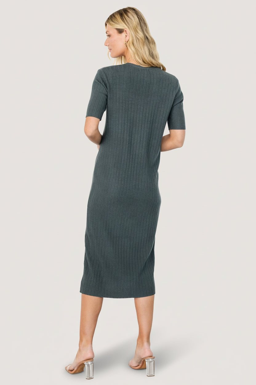 Styled look of Alicia dusty jade midi dress paired with sandals, demonstrating casual daytime styling and the dress’s versatile layering potential.