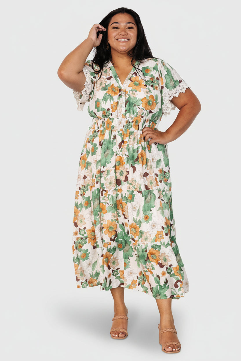 Side profile of Aliyah midi dress highlighting smocked waist, flattering silhouette, and partially lined skirt with floral print.