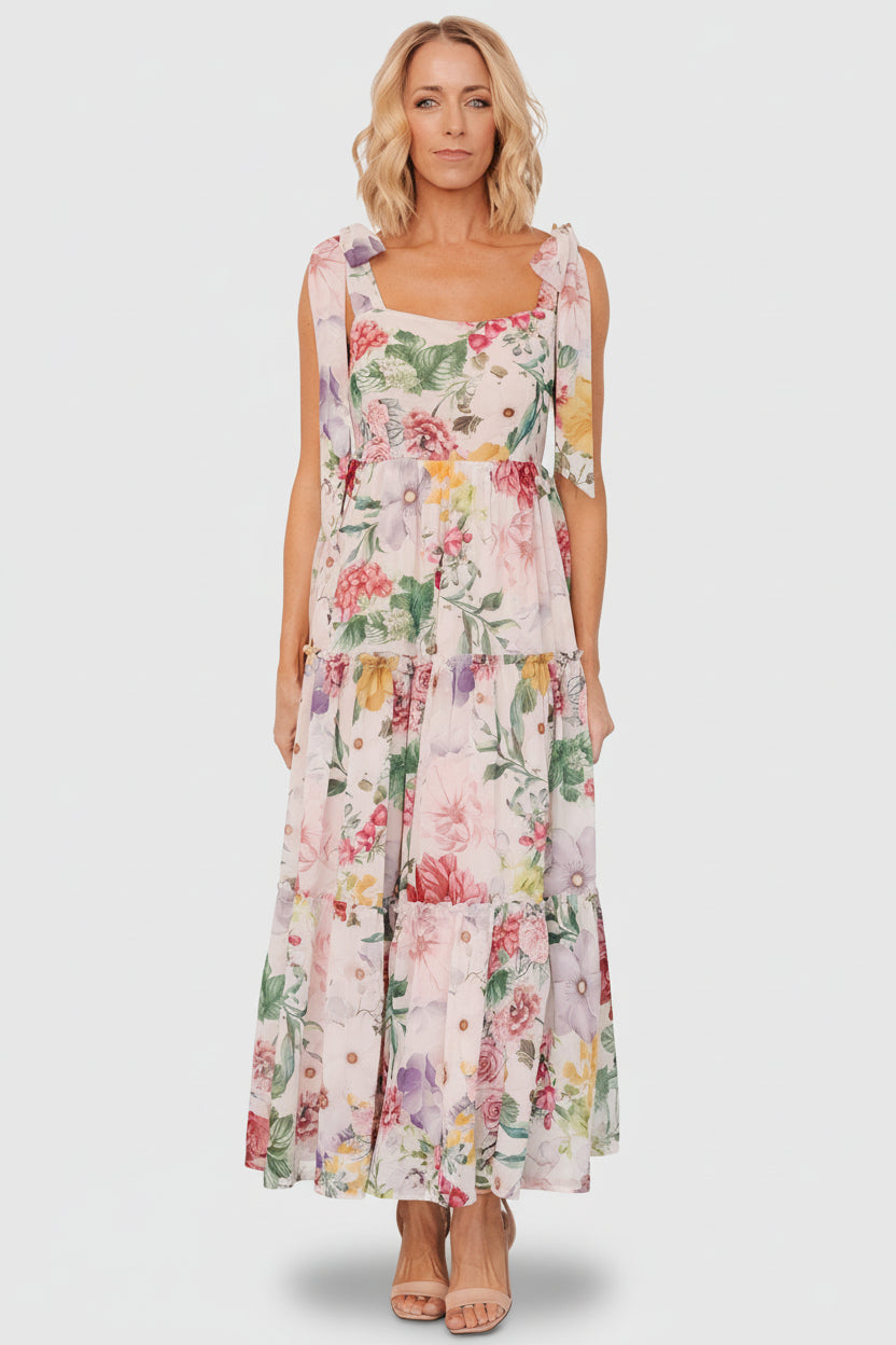 Full-length model view of the blush multi floral maxi dress demonstrating flow, coverage, and occasion-ready styling.